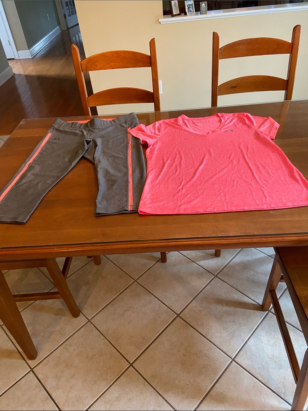 Under Armour Women’s Orange Short Sleeve Top with Gray Capri Leggings.